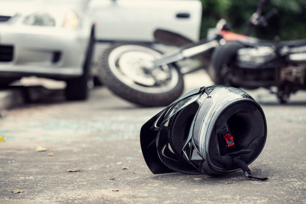 Motorcycle accident scene with truck.